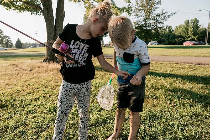 Ann fishing with a half-sibling.